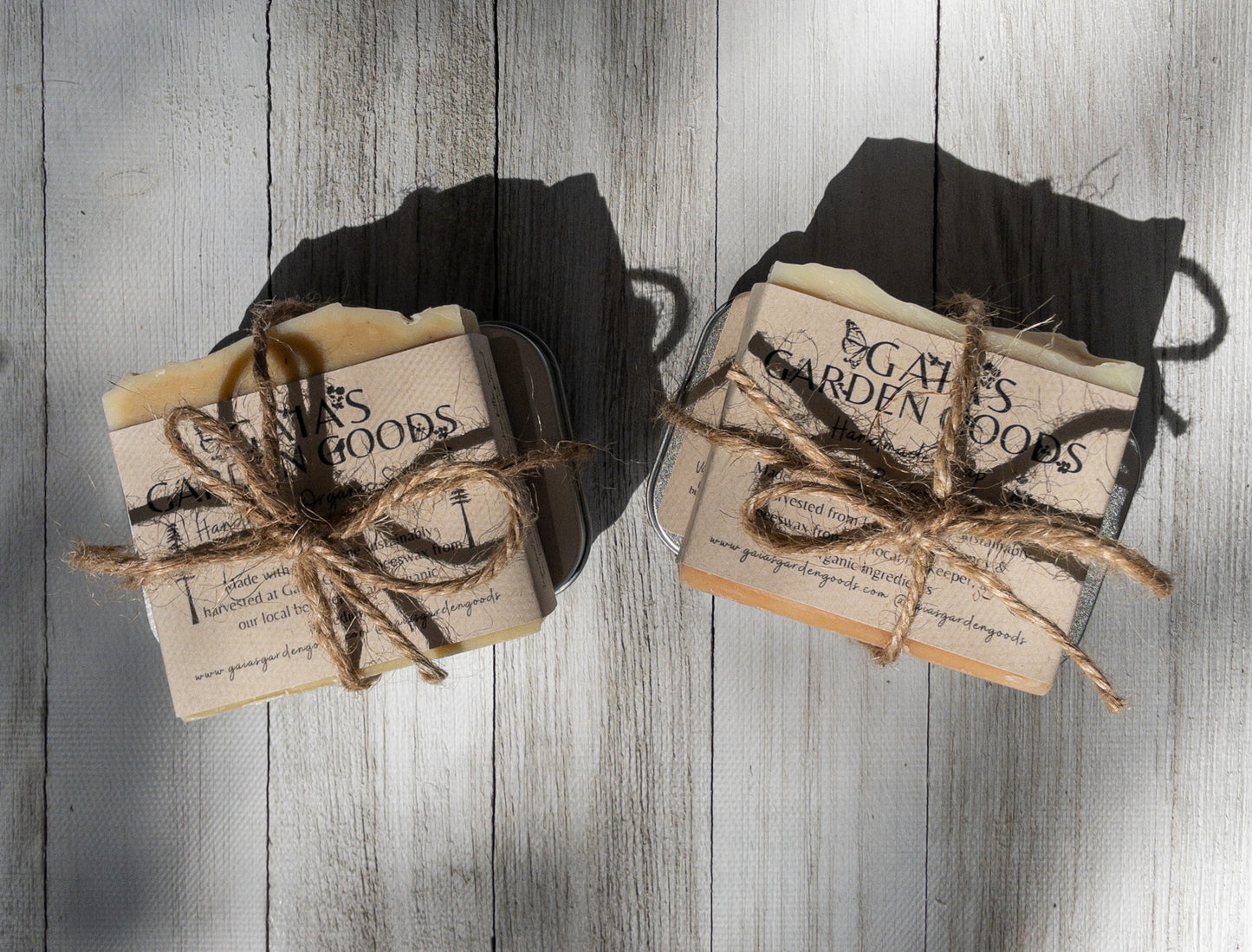 Two soap and lotion sets wrapped in a bow with twine.  Each set contains one soap and one lotion of the same scent. 